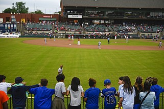 Children play in the stands as they watch the Arkansas Travelers host the Frisco (Texas) RoughRiders during a School Day event at Dickey-Stephens Park in North Little Rock in this April 16, 2024 file photo. (Arkansas Democrat-Gazette/Stephen Swofford)
